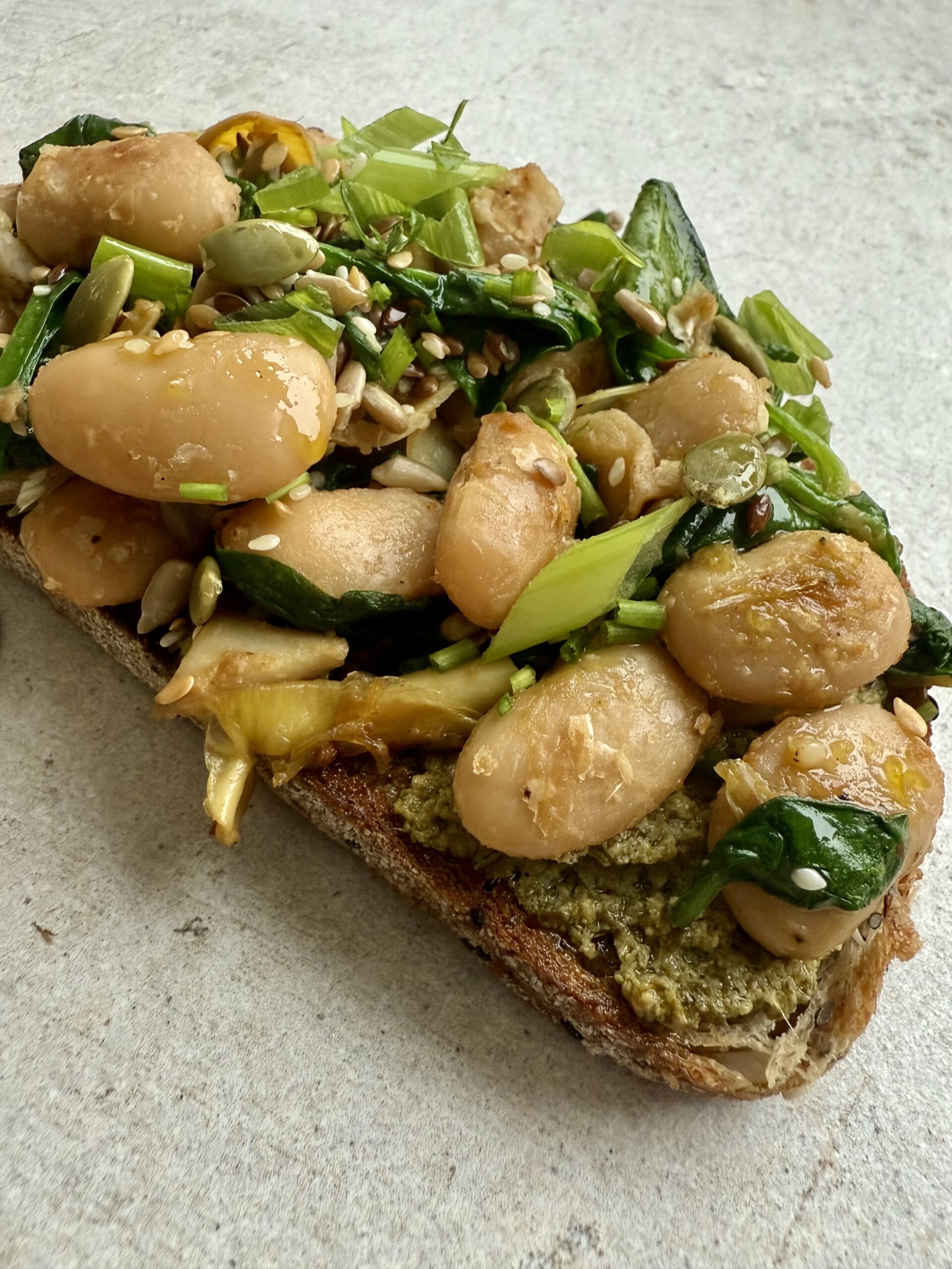 Emma's miso beans artichoke hearts on pesto toast
